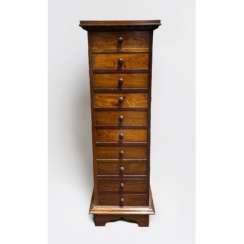 701 - A modern stained walnut tall narrow chest of ten narrow drawers with turned pulls, 36cm wide x 113cm... 