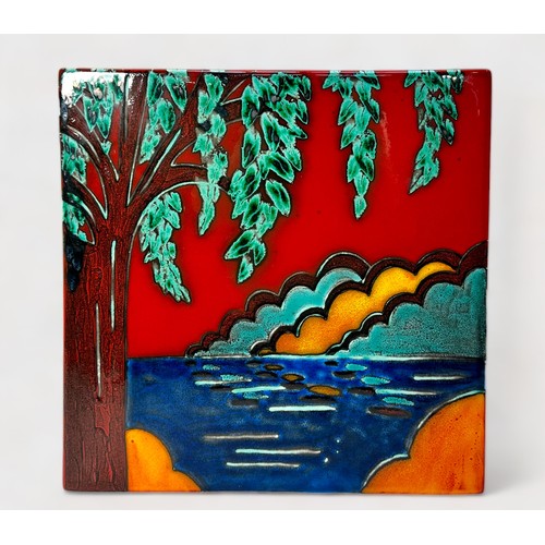 70 - A contemporary studio pottery square panel by Anita Harris, decorated with a tree by water with styl... 