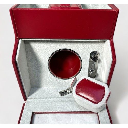 175 - A red leather watch winder by Davidts, model ‘DAV3350’, with storage compartment to top, mains and b... 