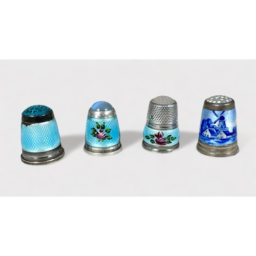 385 - Four white metal and enamel thimbles with moonstone/hardstone crowns. internally stamped 925.S