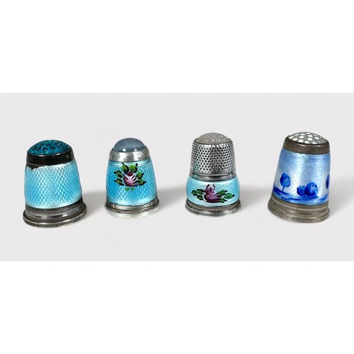 385 - Four white metal and enamel thimbles with moonstone/hardstone crowns. internally stamped 925.S