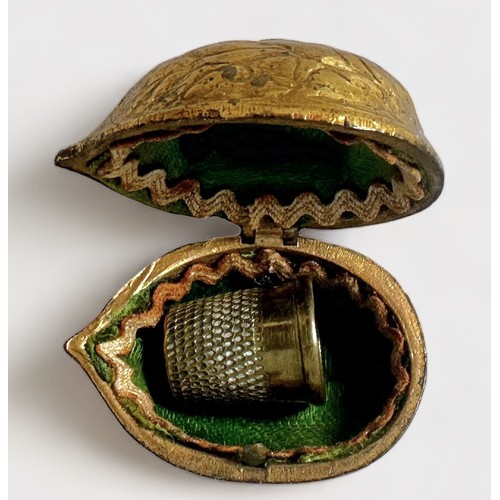 394 - A 19th Century Novelty Gilt-Brass Thimble Case, of hinged form enclosing the original woven green si... 