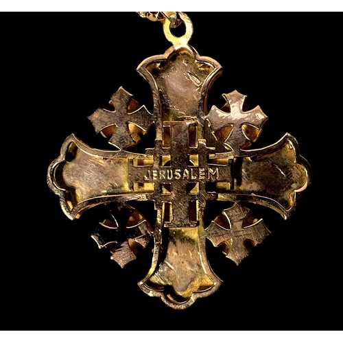 267 - A yellow metal, tests as 14ct gold, Jerusalem cross pendant, centrally bezel set with an amethyst co... 