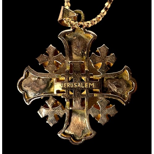 268 - A yellow metal, tests as 14ct gold, Jerusalem cross pendant, centrally bezel set with a topaz colour... 