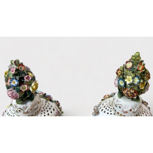 80 - A pair of 19th c entury Dresden 'style' flower-encrusted pierced pot-pourri vases and covers with ch... 