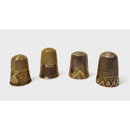 411 - Four various early 20th century gold-cased thimbles