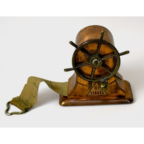 349 - A Novelty brass and copper Tape Measure modelled as a Ship's Wheel, Rd.128885, 4cm high