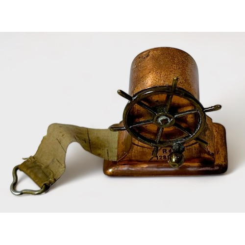 349 - A Novelty brass and copper Tape Measure modelled as a Ship's Wheel, Rd.128885, 4cm high