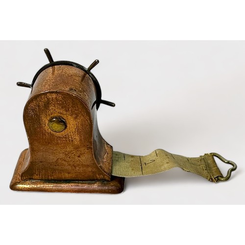 349 - A Novelty brass and copper Tape Measure modelled as a Ship's Wheel, Rd.128885, 4cm high