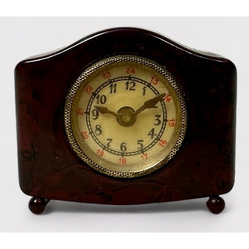 350 - A Novelty Tape Measure modelled as a Bakelite Mantel Clock, the hands moving when the tape is pulled... 