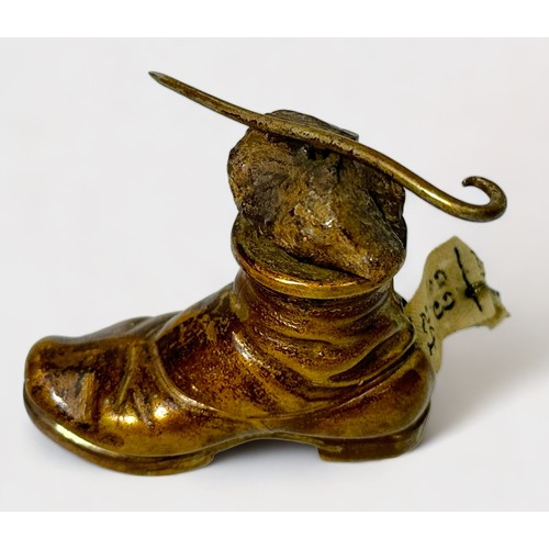 348 - A Novelty Gilt Brass Tape Measure modelled as a Hobnail Boot with a rock and walking stick balanced ... 