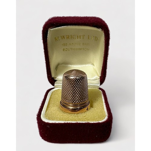 404 - A Late Victorian 9ct gold thimble, of typical dimpled form with harrow horizontal band at the base, ... 