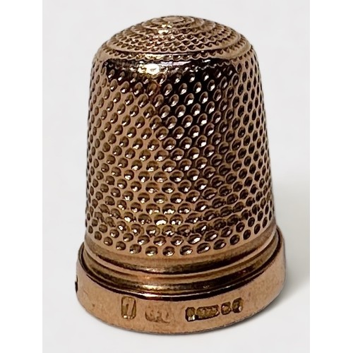 404 - A Late Victorian 9ct gold thimble, of typical dimpled form with harrow horizontal band at the base, ... 