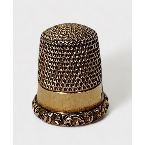 406 - An antique gold thimble, typical form with dimpled crown and skirt, plain frieze with with foliate c... 