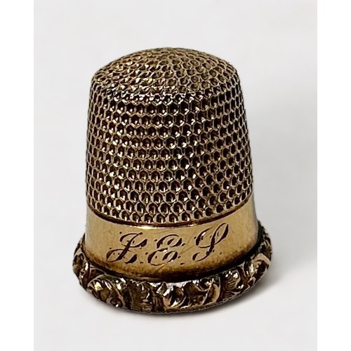 406 - An antique gold thimble, typical form with dimpled crown and skirt, plain frieze with with foliate c... 