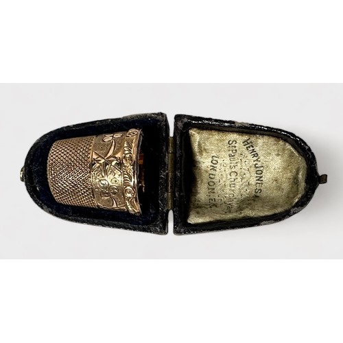 405 - An antique gold thimble, of typical form with dimpled crown and skirt, the frieze with stylised foli... 