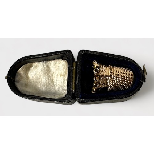 399 - A late Victorian gold thimble, of typical form with dimpled crown and skirt, the lower frieze chased... 