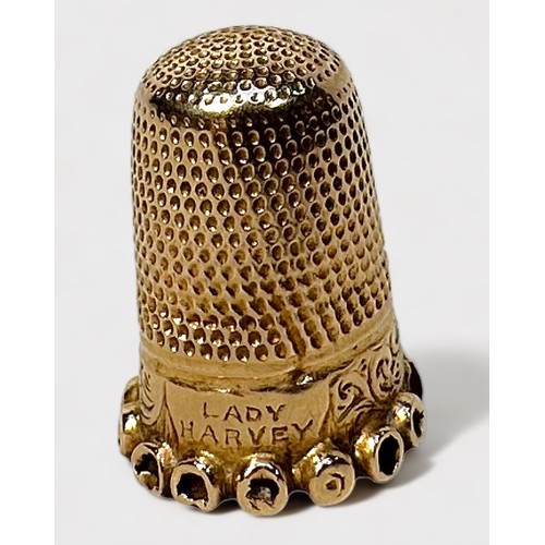 399 - A late Victorian gold thimble, of typical form with dimpled crown and skirt, the lower frieze chased... 