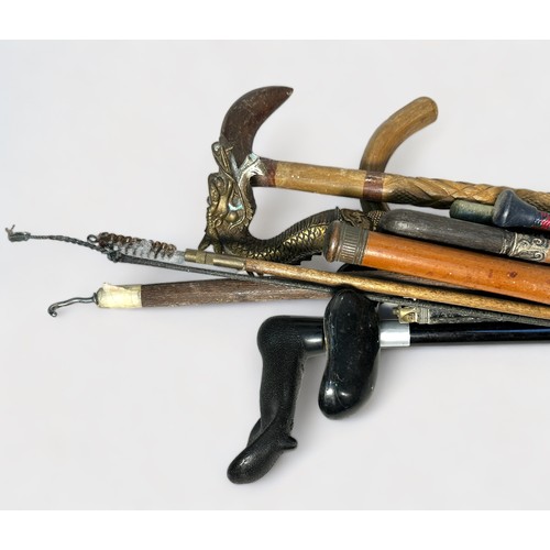 A quantity of assorted walking and swagger sticks, etc, including a ...