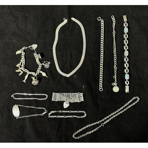 140 - A collection of assorted silver bracelets and necklaces, including a gate bracelet with heart locket... 