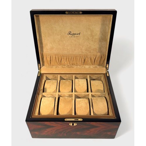 127 - A Rapport London burr wood effect watch box, with lined and compartmented interior with eight sectio... 