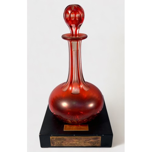 22 - A 19th century Bohemian cranberry glass vase, of compressed globular form with hexagonal neck and fl... 