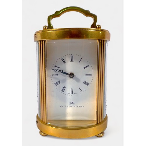 501 - A Swiss made gilt brass-cased carriage clock of circular form, white enamel dial with Roman numerals... 