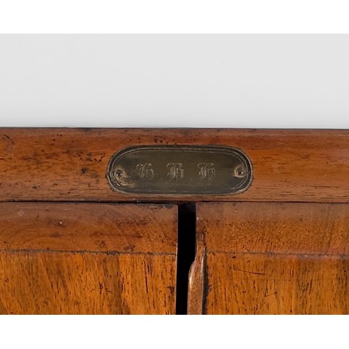 333 - A 19th Century walnut desk tidy/writing comopendium with sloped front and two hinged doors enclosing... 