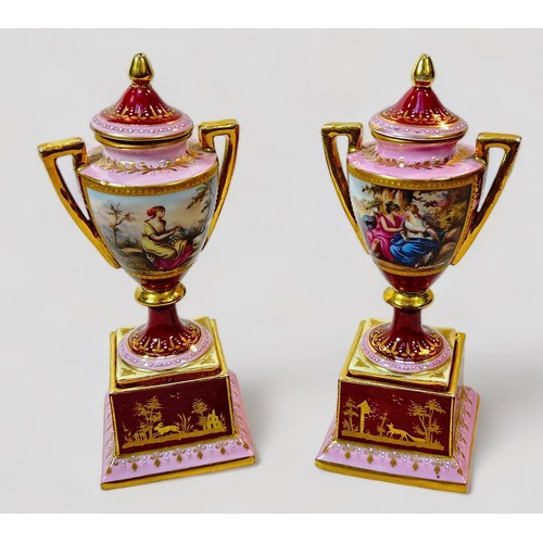 33 - A pair of 19th century Viennna Porcelain pedstal vases and covers, with rouge grounds and pink bands... 