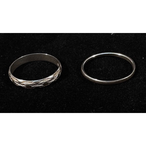 175 - A white gold wedding ring, 3.58g, together with a platinum wedding band, 2.15g, (2)