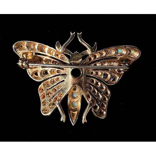 173 - A 9ct gold Butterfly brooch, with ruby eyes, the wings and abdomen set with sapphires, cabochon opal... 