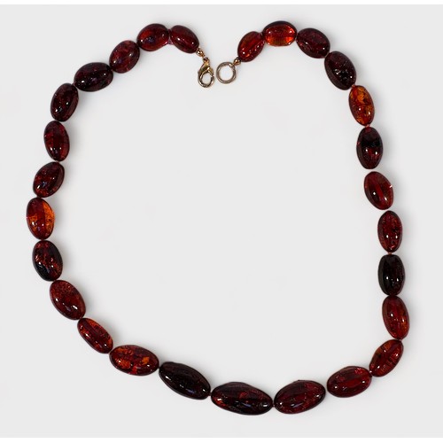 168 - A Cognac Amber Bead Necklace, graduated ovoid beads 25x11mm to 14x8mm, good natural inclusions, 50cm... 