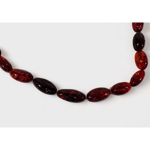 168 - A Cognac Amber Bead Necklace, graduated ovoid beads 25x11mm to 14x8mm, good natural inclusions, 50cm... 