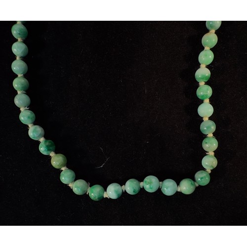 167 - A Chinese graduated Jade bead necklace, individually knotted variegated green beads measuring 6mm to... 