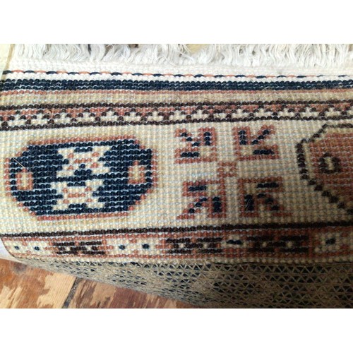 514 - A hand-knotted Caucasian wool fringed rug, with three cental guls to a black ground within a border ... 