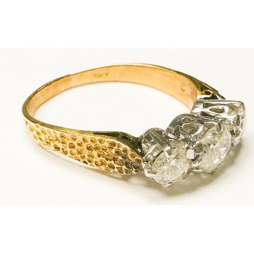 203 - An 18ct yellow gold ring, claw set with three round brilliant cut diamonds, centre stone estimated 0... 