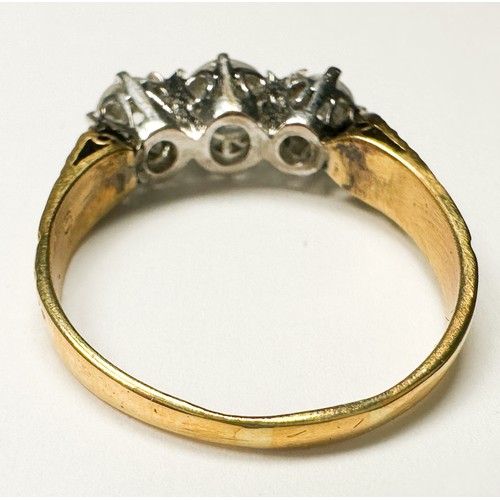 203 - An 18ct yellow gold ring, claw set with three round brilliant cut diamonds, centre stone estimated 0... 