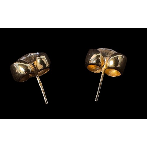 248 - A pair of 9ct gold earrings, each set with a large white circular faceted stone, gross weight approx... 