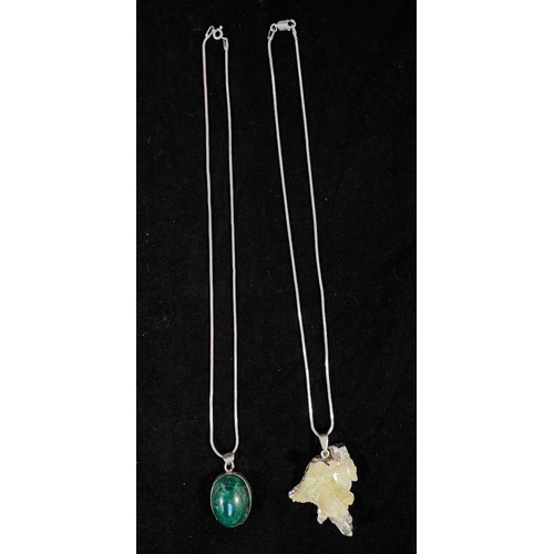 242 - Two silver chains, one set with an oval cabochon malachite, the other with a naturalistic quartz