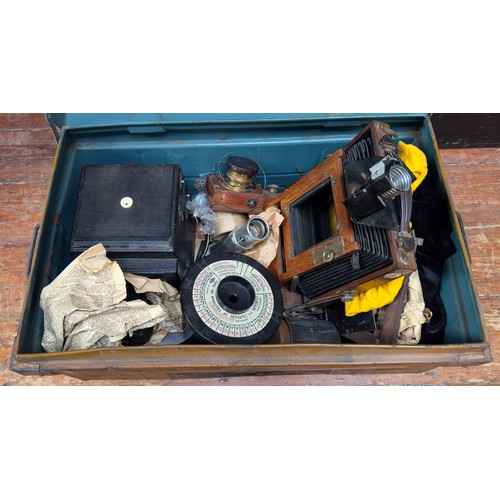 494 - A metal trunk containing various box camera peripherals, including The Westminster Photographic Exch... 