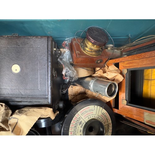 494 - A metal trunk containing various box camera peripherals, including The Westminster Photographic Exch... 