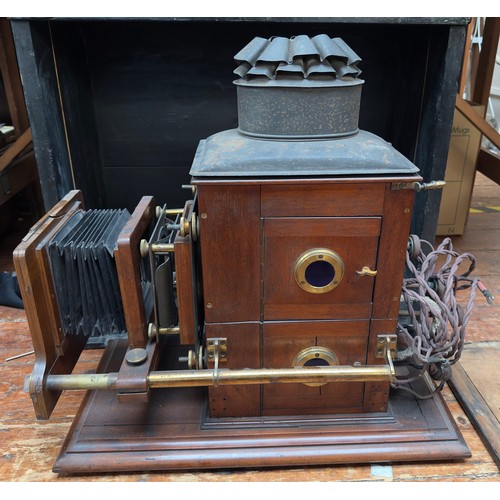 493 - A late 19th Century mahogany and brass box camera by W. Watson & Sons, the applied brass plaque insc... 