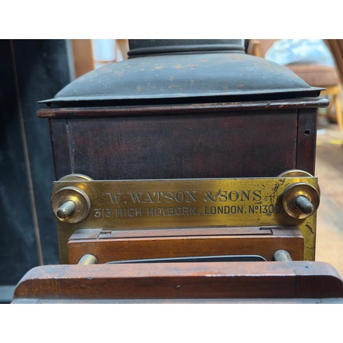 493 - A late 19th Century mahogany and brass box camera by W. Watson & Sons, the applied brass plaque insc... 