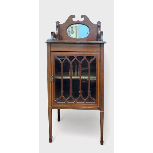 617 - An Edwardian mahogany music cabinet, shaped and inlaid gallery centred by oval bevelled mirror, sati... 