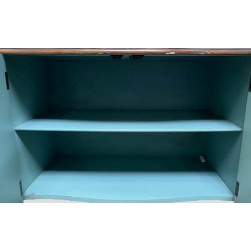 620 - A Continental commode cupboard, of serpentine form, the walnut top above a floral painted aqua blue ... 