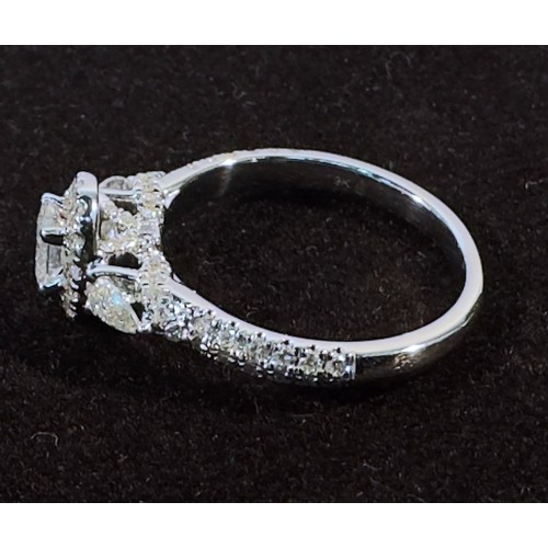 256 - A White Gold and Diamond Ring, centrally four-claw set with an oval faceted diamond with rbc diamond... 