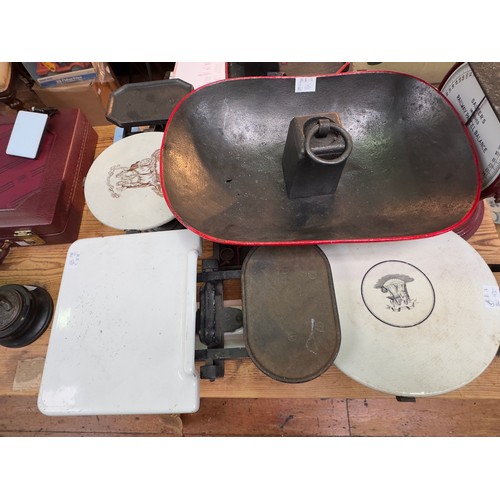 366 - A collection of various cast iron and ceramic weighing scales, with an assortment of iron and brass ... 