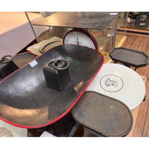 366 - A collection of various cast iron and ceramic weighing scales, with an assortment of iron and brass ... 