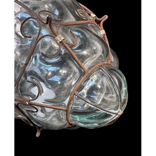 521 - A Continental mould-blown hanging light of ovoid form with outer wrought metal wire frame, 45cm long... 