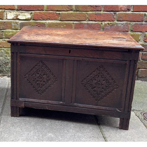 619 - A 17th Century oak coffer, two panel front with ornately carved diamond lozenge, wrought iron mounts... 